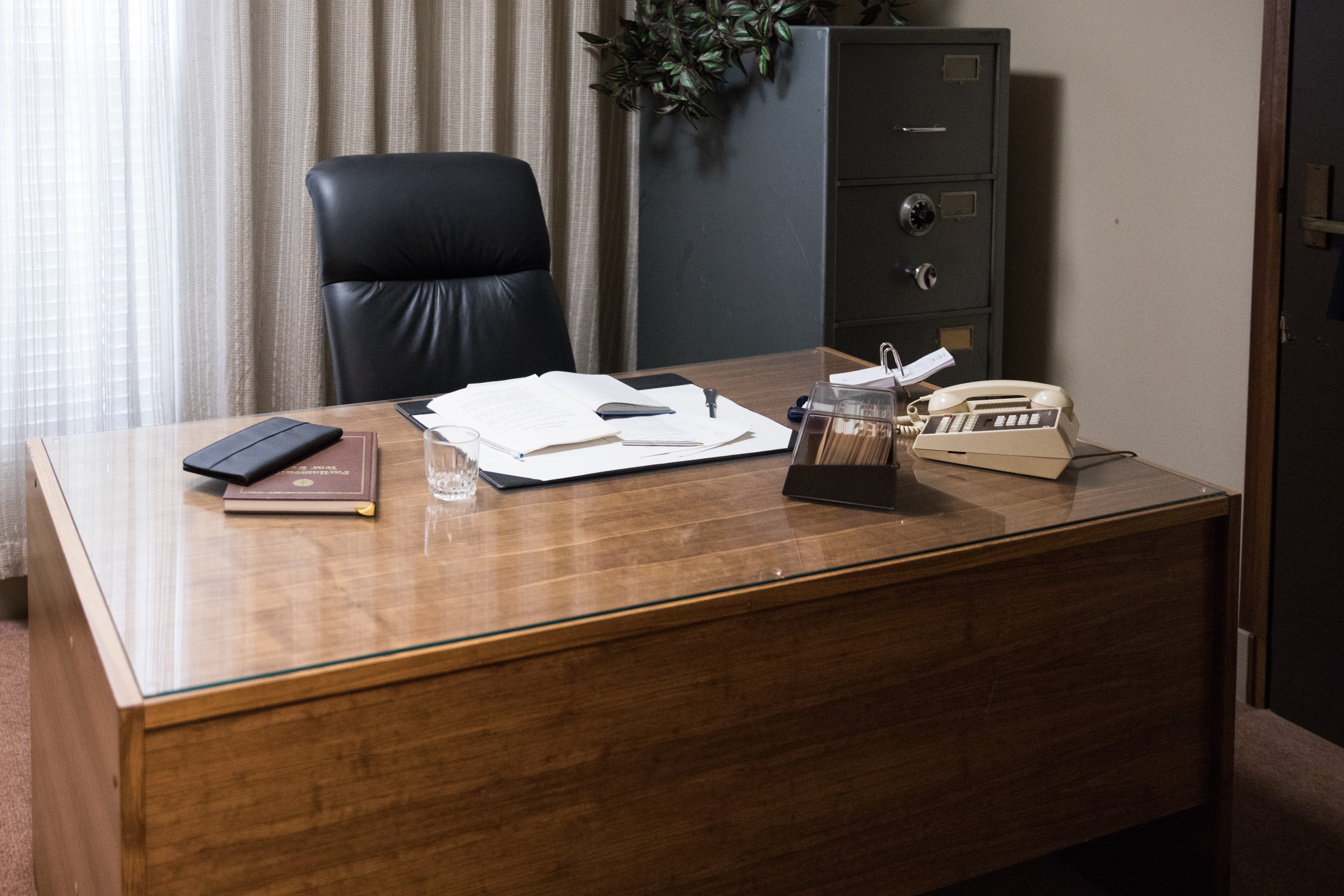 Professional office space with custom wooden desks, ergonomic chairs, and organized storage solutions